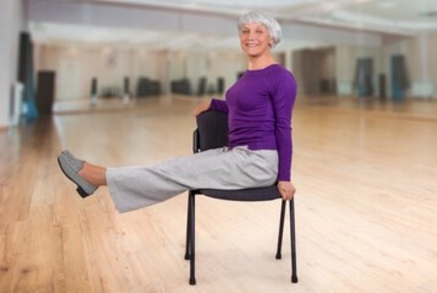 Senior participants doing gentle yoga stretching in a group class