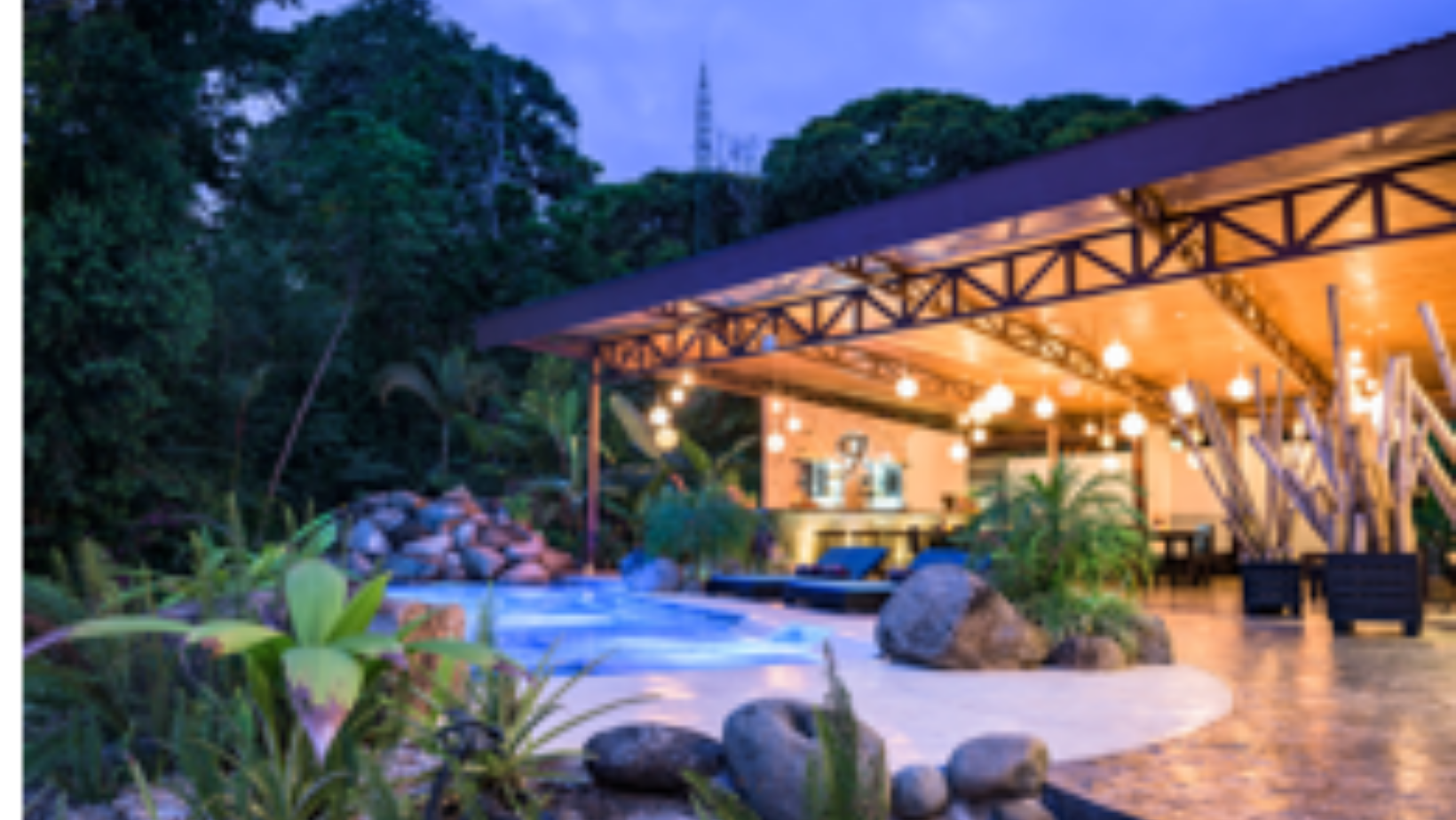 Outdoor patio with pool and jungle landscape at yoga retreat