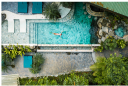 Relaxing blue swimming pool in tropical environment